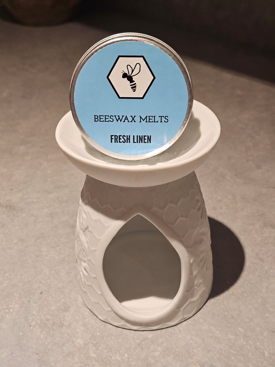 White tea light wax melt burner with a tin of Fresh Linen beeswax melts
